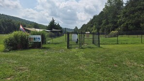 A fenced park entrance with a sign, a grassy area, and a mountain in the background. - Newly Renovated Slopeside Condo at Bryce Resort. Family and pet-friendly! (Mount Jackson)