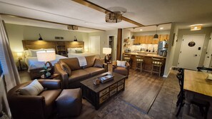 A hotel room with a living area, a kitchenette, and a separate bedroom. - Newly Renovated Slopeside Condo at Bryce Resort. Family and pet-friendly! (Mount Jackson)