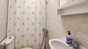 Ein Badezimmer mit Toilette, Dusche und Waschbecken.