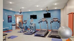 A fitness center with treadmills, elliptical machines, and a large exercise ball. - Urban 1BR Downtown Delight (Salt Lake City)