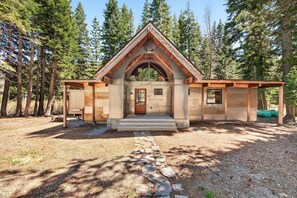 A rustic cabin with a stone foundation, wooden beams, and a pitched roof. - Marigold Cabin by Tahoe Getaways - 3BR in Alpine Meadows w/ Ski Shuttle! (Alpine Meadows)