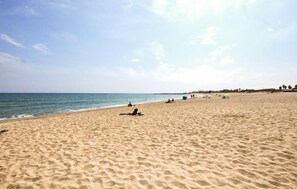 A sandy beach with people sunbathing and a clear sky. - 5 bedroom cozy home in Sainte Marie La Mer Pl (Sainte Marie La Mer Pl)