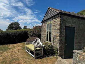 A stone cottage with a single window, a door, and a bench outside. - Ventnor 4-Bed House, Sleeps 8, Parking  & Pets Ok (Ventnor)
