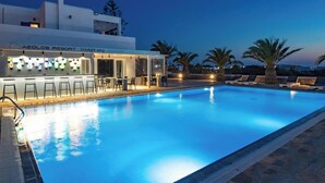 A swimming pool with a bar area, lounge chairs, and a restaurant named 'Aeolos Resort.' - Aeolos Resort (Mykonos)