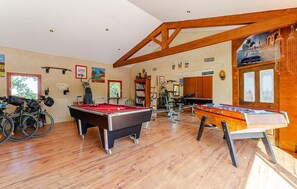 A recreational room with pool tables, exercise bikes, and bicycles. - Stunning home in Robion (Robion)