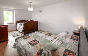 A bedroom with a wooden bed, a bedside table with a lamp, a window with a view, and a radiator. - Amazing home in Saint-Alban-d'Ay with WiFi (Saint-Alban-d'Ay)