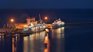 A large cruise ship docked at a port with industrial structures in the background. - Hotel Ideale (Ortona)