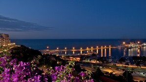 A coastal cityscape at night with illuminated buildings, a marina, and a bridge. - Hotel Ideale (Ortona)