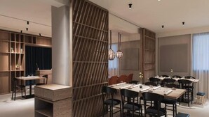 A modern dining area with a long table, chairs, and a decorative partition. - Franco Il Conte (Bagheria)