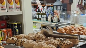 A bakery display with various breads and pastries, including croissants and seeded rolls. - B&b Hotel Dolomiti (Bolzano)
