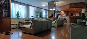 A spacious lobby with a sofa set, a coffee table, and a reception desk. - Park Hotel Galileo (Reggello)