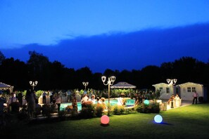 An outdoor gathering with tables and chairs, a pool, and decorative lighting. - Villa Belvedere 1849 (Misano di Gera d'Adda)
