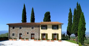 A two-story stone building with a tiled roof, surrounded by tall cypress trees. - Poggio Desto Bed & Breakfast (Quarrata)