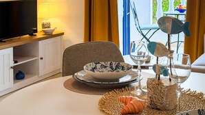 Uma mesa de jantar com uma tigela, um copo de vinho e objetos decorativos.