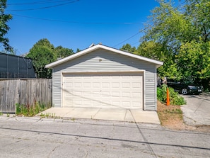 A single-story garage with a white garage door, a small overhang, and a number '2013' on the right side. - Lavender Hill Skyline - Sleeps 12 - City Views (Milwaukee)