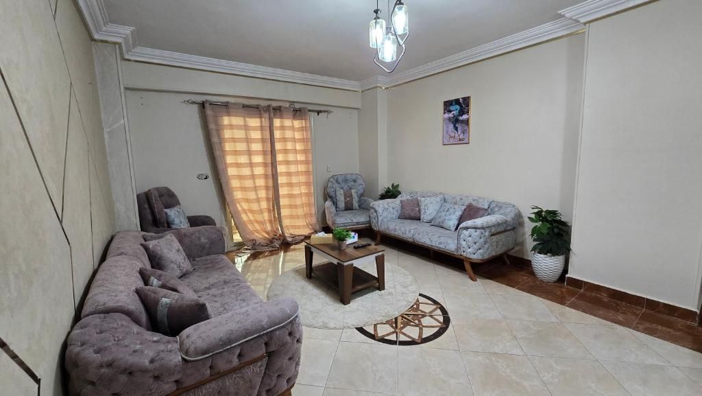 A living room with a sofa, armchair, and a coffee table.