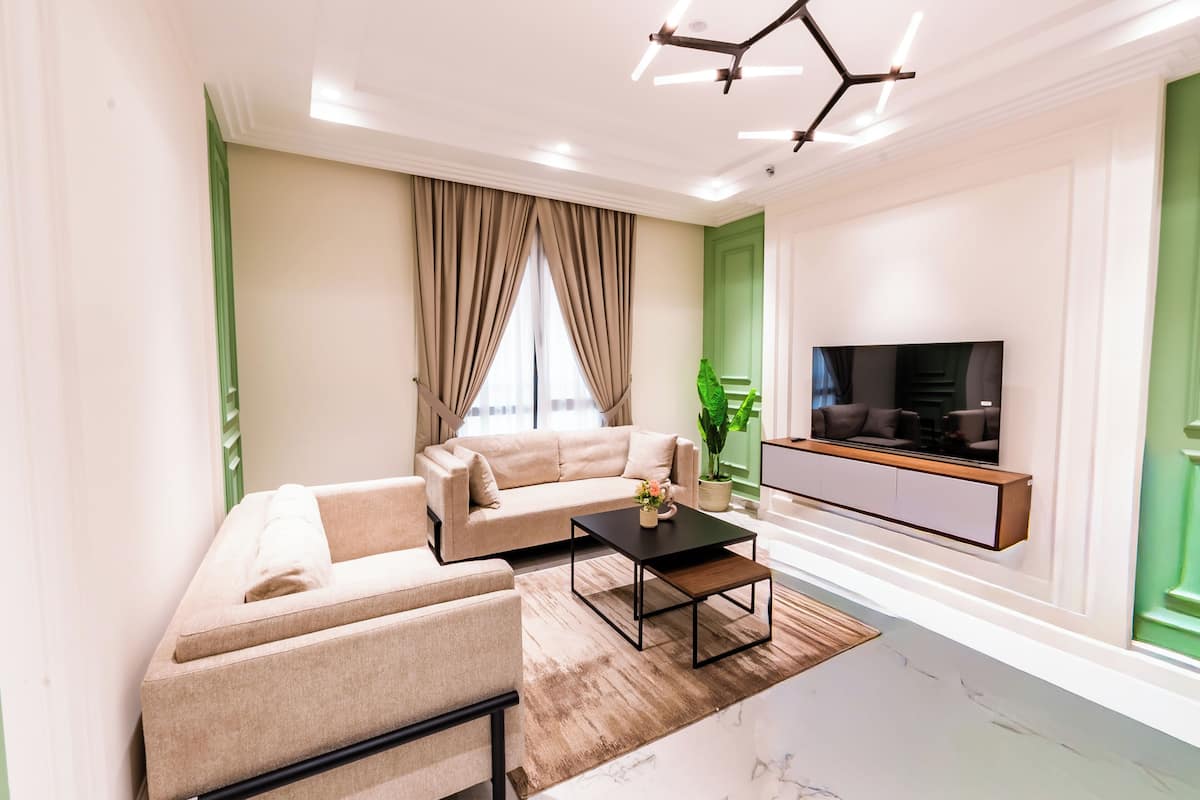 A modern living room with a sofa, coffee table, and TV.