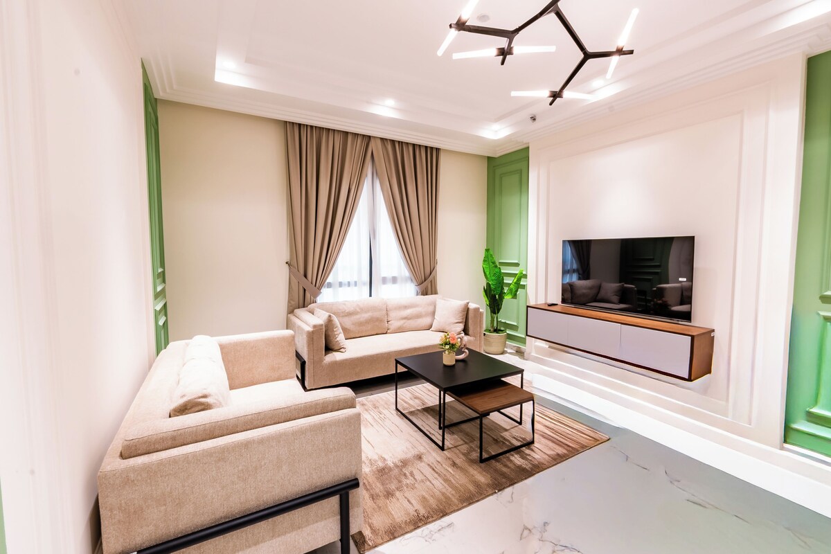 A modern living room with a sofa, coffee table, and TV.