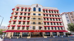 Ein mehrstöckiges Hotel mit rotem Markisen und Balkonen.
