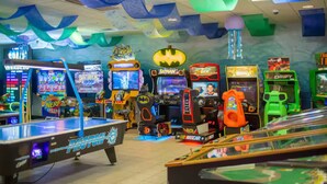 A room with arcade games, a pool table, and colorful decorations. - Emmas Beach Hut 2 KING BEDS 3 min to beach (Myrtle Beach)