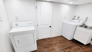 A laundry room with a washer, dryer, and sink. - Central Moncton 2BR | Walk, Pets & Parking (Moncton)