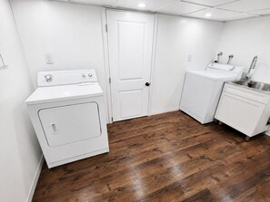 A laundry room with a washer, dryer, and sink. - Central Moncton 2BR | Walk, Pets & Parking (Moncton)