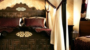 A bed with a patterned headboard and a canopy. - Isa Begov Hamam Hotel (Sarajevo)