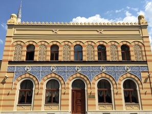 A hotel facade with a row of arched windows and a central entrance door. - Isa Begov Hamam Hotel (Sarajevo)