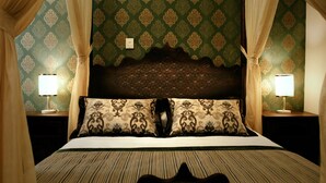 A hotel room with a bed, two nightstands, lamps, and curtains. - Isa Begov Hamam Hotel (Sarajevo)
