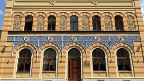 A hotel facade with a row of arched windows and a central entrance door. - Isa Begov Hamam Hotel (Sarajevo)