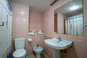 A bathroom with a toilet, bidet, sink, and mirror. - Hotel Le Grand Imilchil (Marrakech)