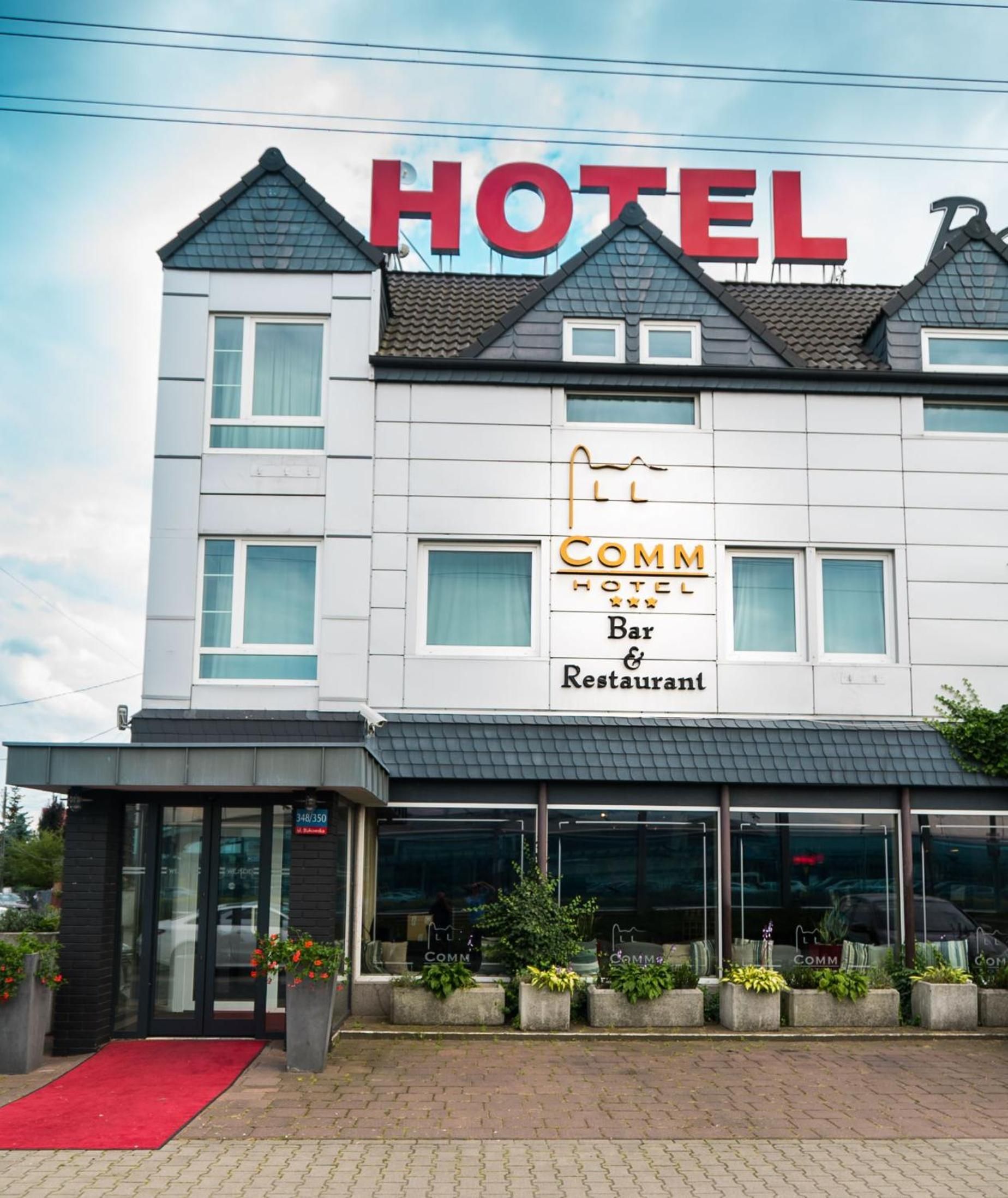 A hotel with a prominent sign indicating it has a bar and restaurant.