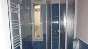 A bathroom with two toilets, a shower enclosure, and a towel rack. - Affittacamere Andronaco (Milan)