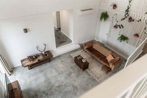 Ein modernes Wohnzimmer mit einer Couch, einem Couchtisch und Dekorationselementen.