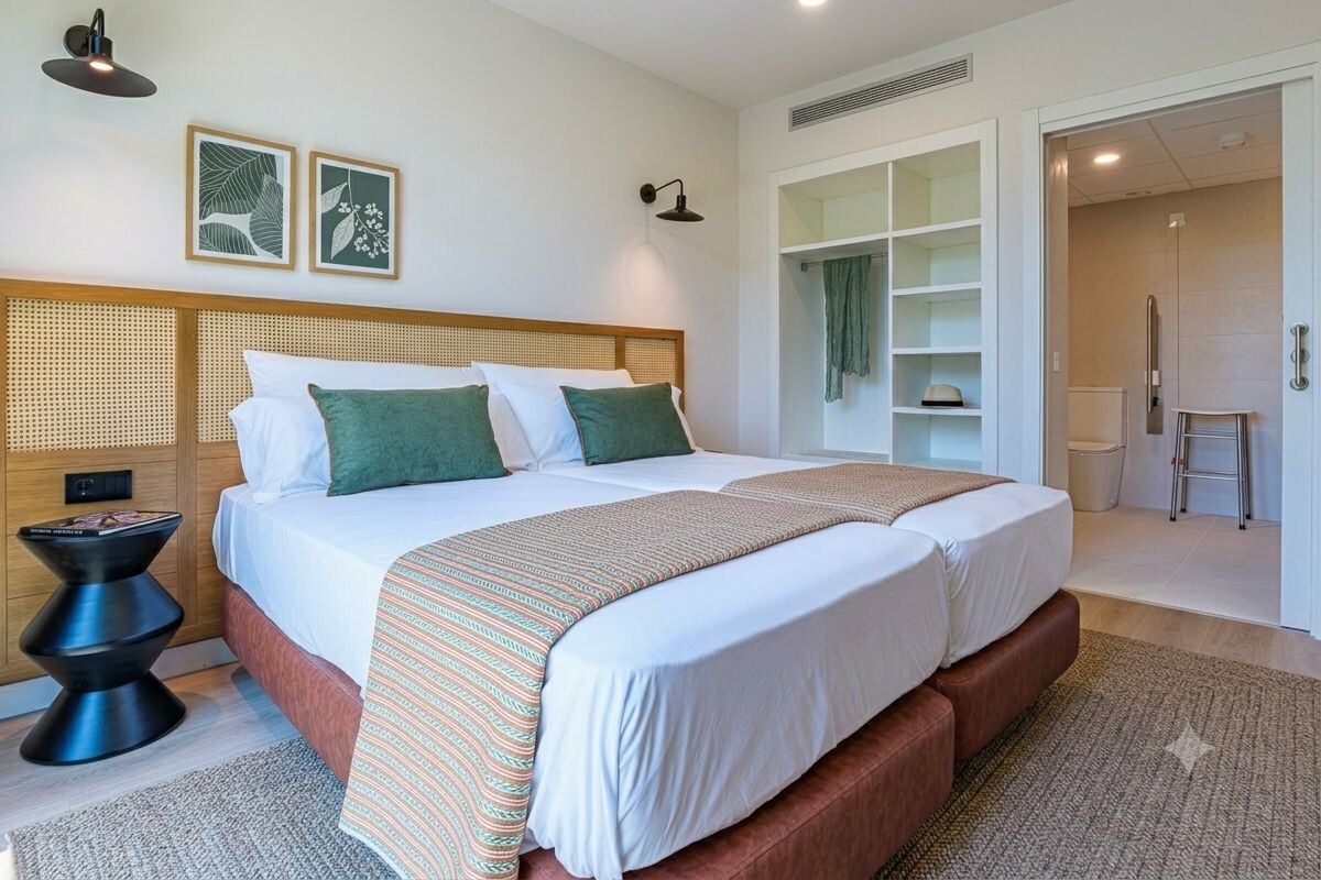 A modern bedroom with a large bed, bedside tables, and a walk-in closet.