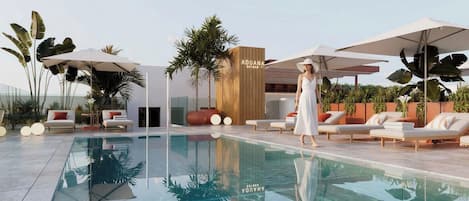 A modern pool area with lounge chairs, umbrellas, and a bar area.