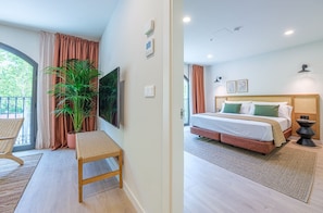 A bedroom with a bed, bedside tables, a mirror, and a window with curtains. - Aduana Suites (Salou)