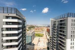 A modern high-rise building with multiple balconies and a clear view of the surrounding cityscape. - Bastion Wałowa Skyline Apartment #1 (Gdańsk)