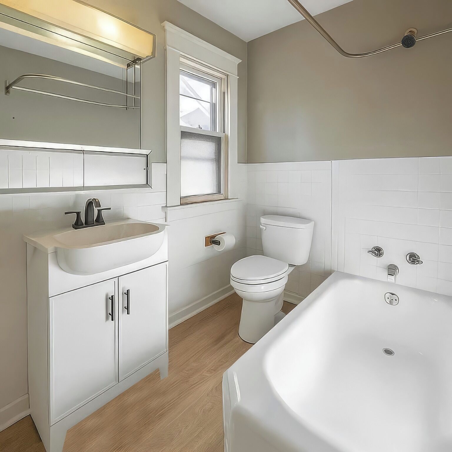 A bathroom with a white sink, toilet, and bathtub.