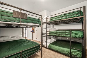 A bunk bed room with green bedding, a metal ladder, and a small window. - Skyline 3 Homes Retreat, Private Swim Spas, SLP 48 (Washington)