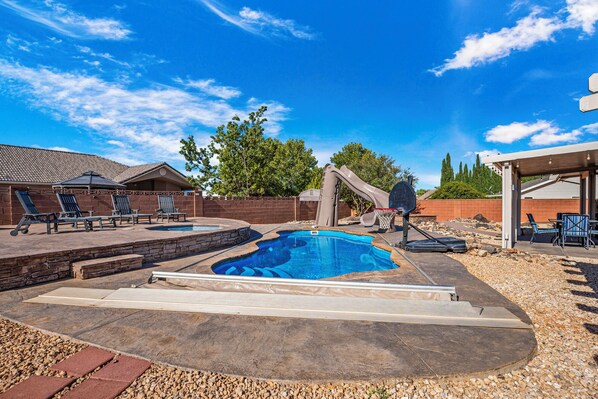A backyard with a swimming pool, a slide, and outdoor seating. - 3819, Private Pool, Private Spa, BBQ, Outdoor Fire Pit, Xbox 1 (Hurricane)