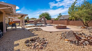 A backyard with a barbecue area, outdoor seating, a fire pit, and a swimming pool. - 3819, Private Pool, Private Spa, BBQ, Outdoor Fire Pit, Xbox 1 (Hurricane)