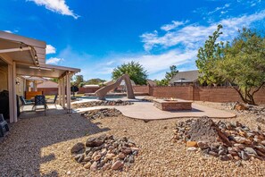 A backyard with a barbecue area, outdoor seating, a fire pit, and a swimming pool. - 3819, Private Pool, Private Spa, BBQ, Outdoor Fire Pit, Xbox 1 (Hurricane)
