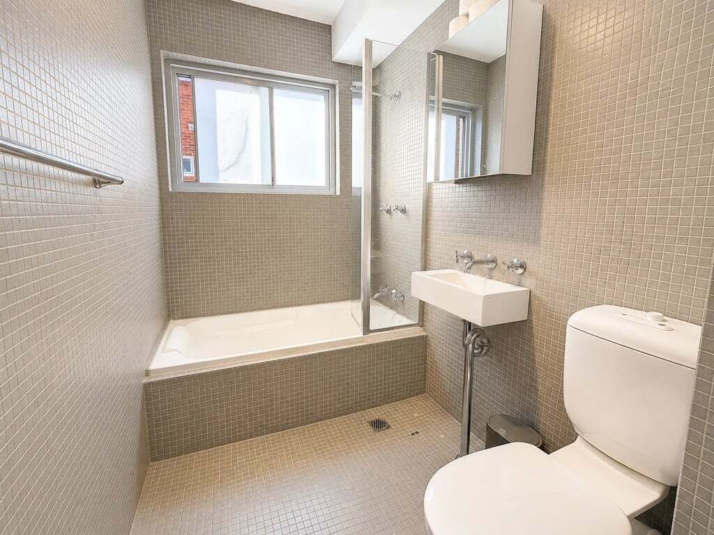 A bathroom with a bathtub, a sink, and a toilet.