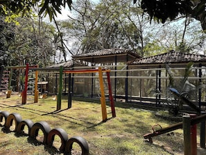 A playground with swings, a climbing structure, and tire swings.