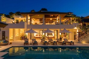 A two-story modern house with a swimming pool, outdoor seating, and a staircase leading to the upper level. - San Suk Villa – 4BR Ocean View Family Tropical Escape (Koh Samui)
