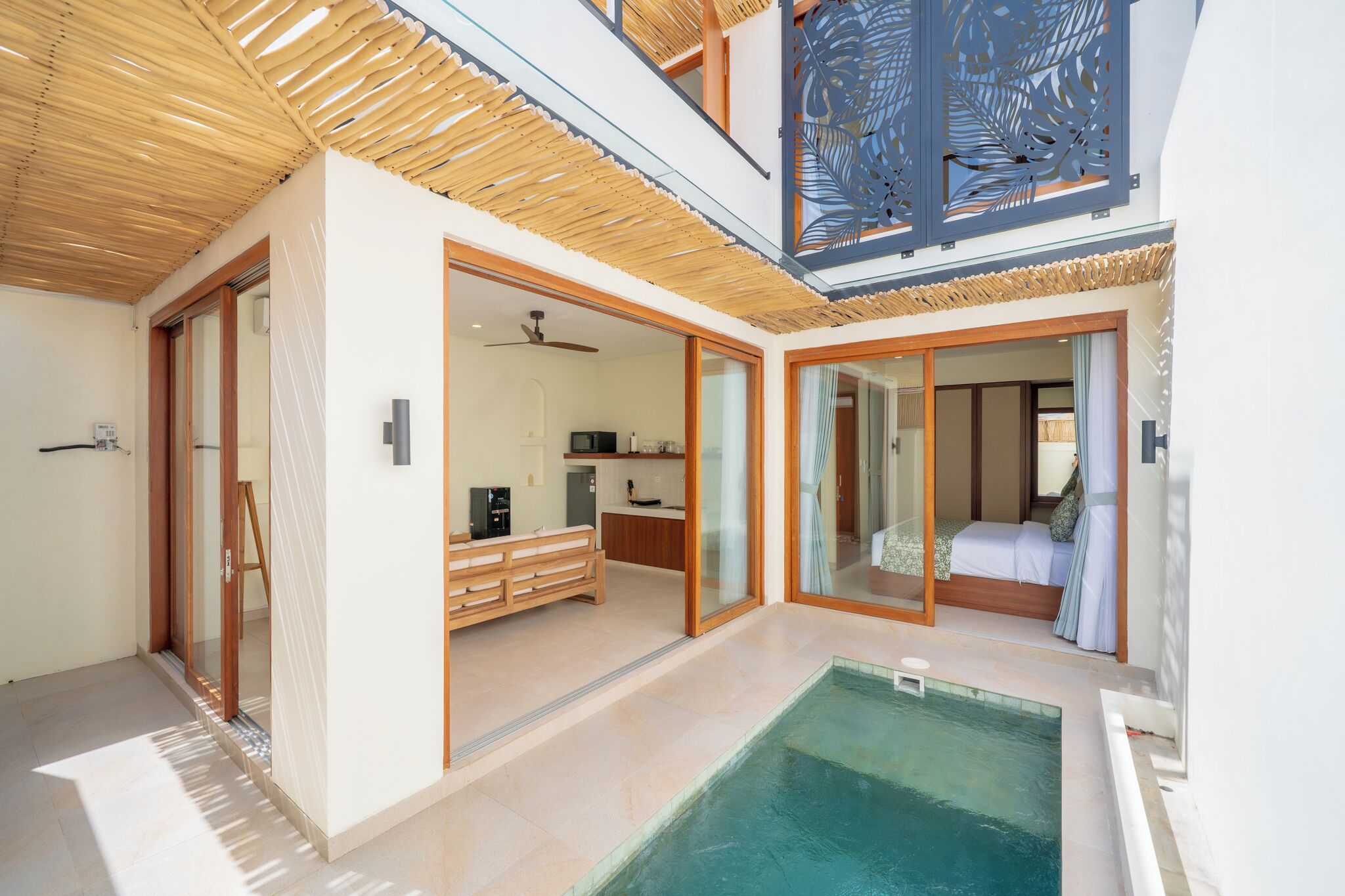 A modern interior with a pool, wooden ceiling, and a kitchen area.