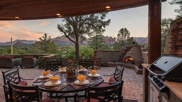 An outdoor patio with a table set for dining, surrounded by chairs, and a barbecue grill. - Sedona Jewel | Panoramic Views, Patio, Hot Tub (Sedona)