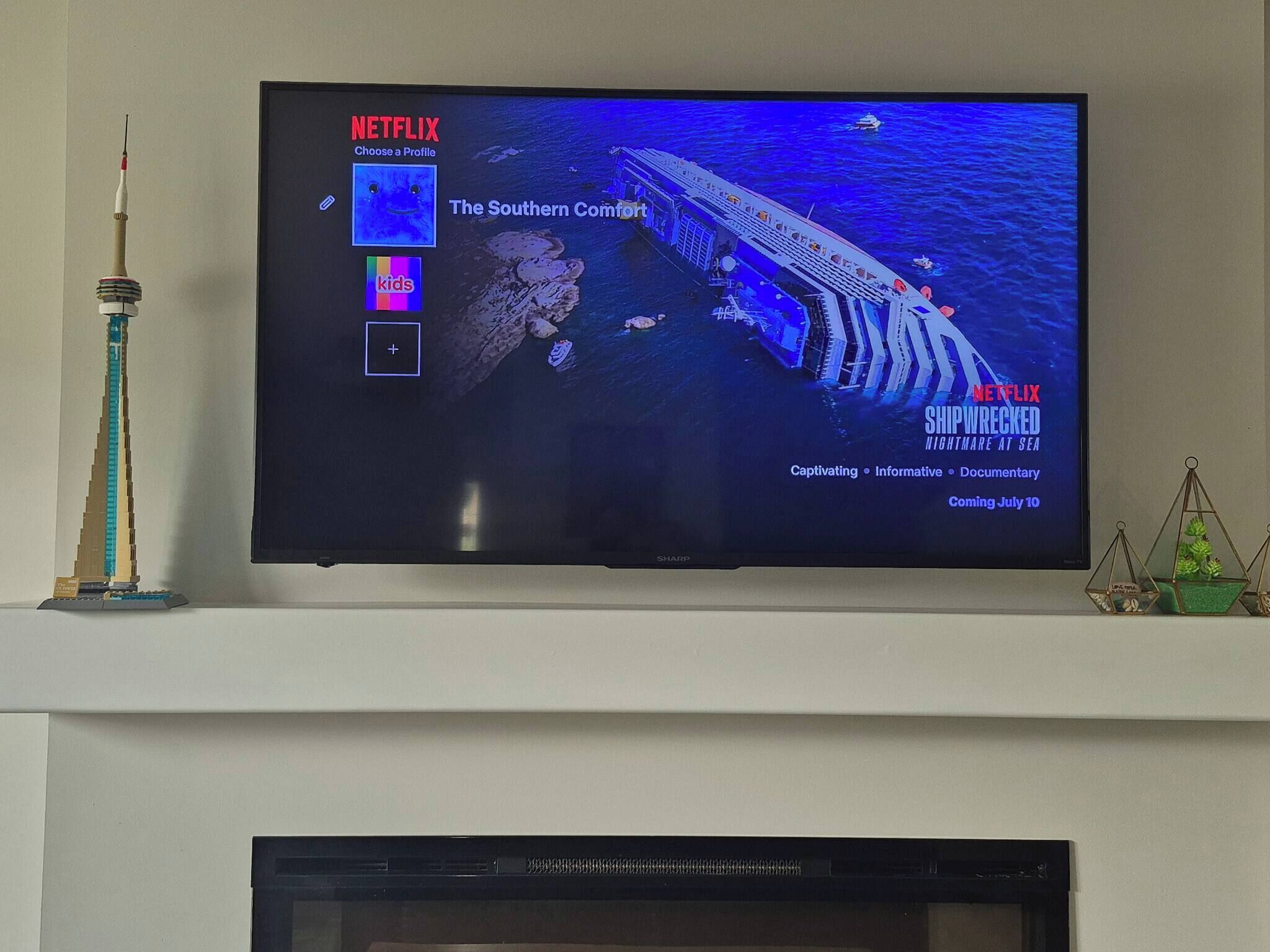 A television displaying a movie scene with a shipwreck.