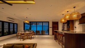A modern interior with a dining area, kitchen, and seating space.